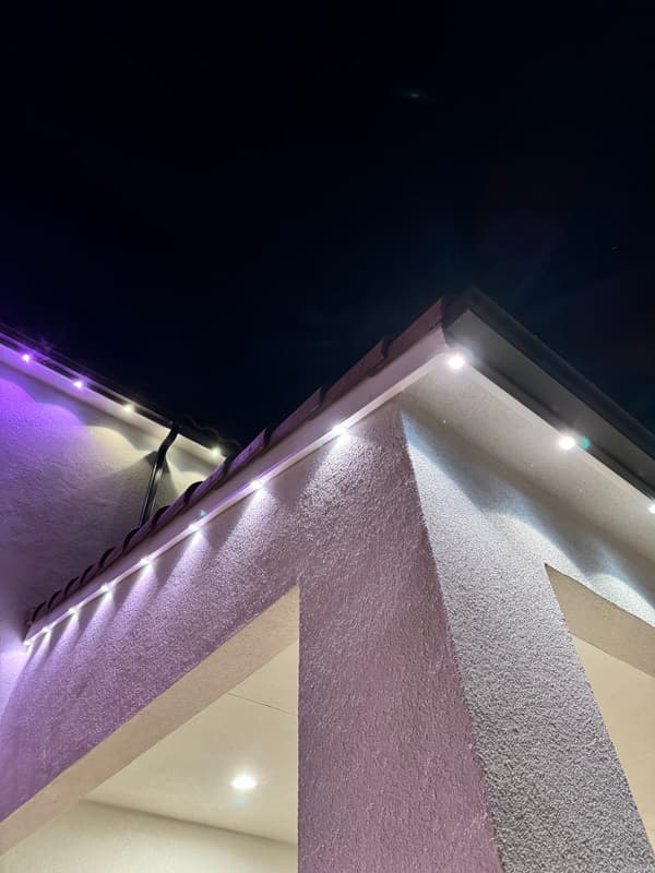 Soffit and eave lit with purple accent lights