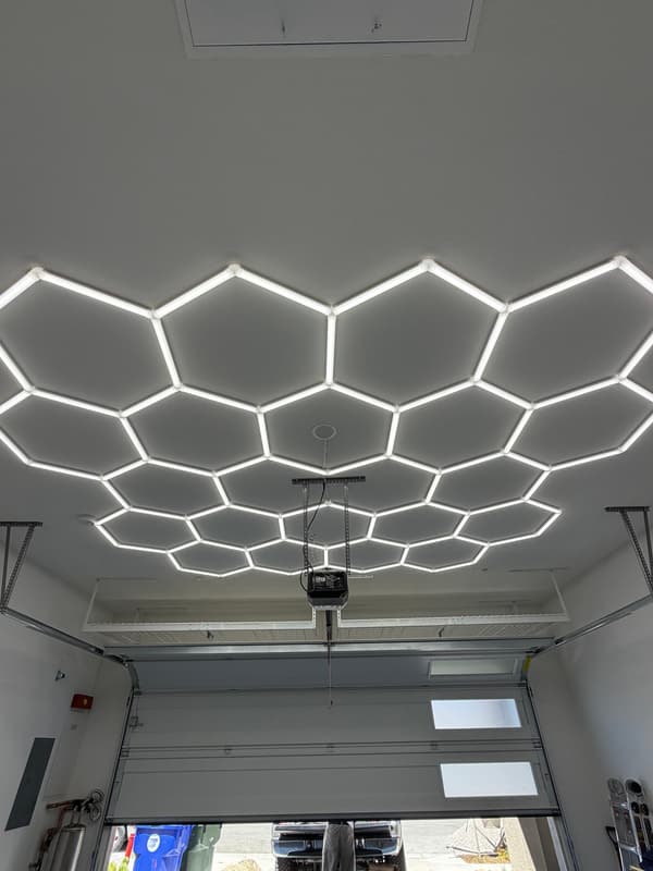 Garage ceiling covered with a white hexagon LED light grid